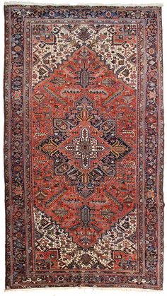 an antique persian rug with red and blue colors