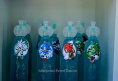 the bottles are lined up on the shelf in the cabinet with cartoon images painted on them