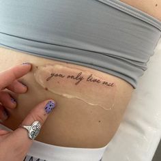 a woman's stomach with the words you only have one tattoo on her belly