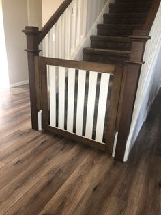 a stair case with white and black stripes on the bottom, next to a wooden banister