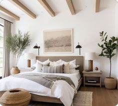 a large bed sitting in a bedroom next to two tables with lamps on top of it