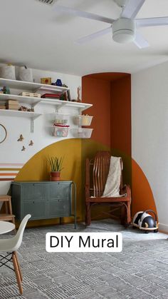 a living room with an orange wall and white ceiling fan in the middle of it