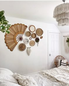 a bedroom with white walls and wicker fan decorations on the wall