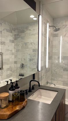 a bathroom with a sink, mirror and soap dispenser on the counter