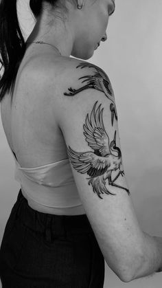 a woman with a bird tattoo on her arm