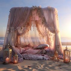 a canopy bed on the beach with candles