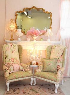 a living room with two chairs and a mirror on top of the table in front of it