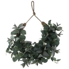 a green wreath hanging from a rope with leaves and flowers on it's end