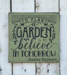 a sign on the side of a building that says to plant a garden is to believe in tomorrow