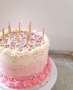 a birthday cake with sprinkles and candles