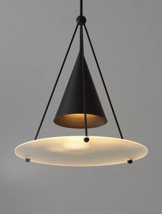 a black and white light hanging from a ceiling