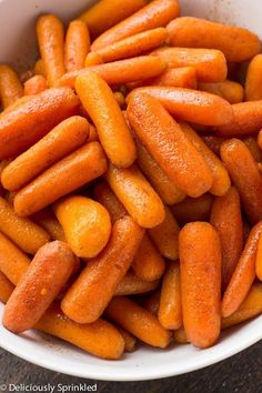 a bowl filled with carrots sitting on top of a table