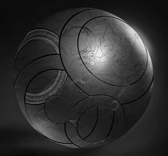 a black and white photo of a round object with circular designs on it's surface