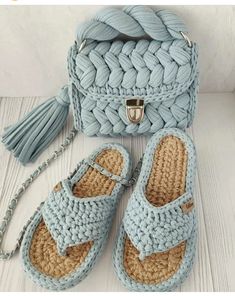 a crocheted bag and sandals are sitting on a white table next to a purse