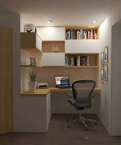 a computer desk with a laptop on top of it in front of a bookshelf