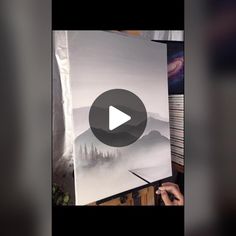 someone is painting a mountain scene with watercolors on the easel, and then it's time to paint