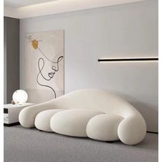 a large white sculpture sitting on top of a bed