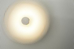 a light that is on in the middle of some glass wallpapered walls and ceiling