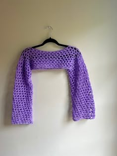 a purple knitted scarf hanging on a wall