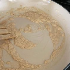 a wooden spoon mixing batter in a white bowl