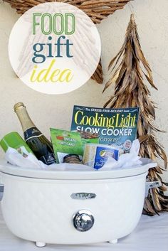 a white crock pot filled with food next to a christmas tree and a sign that reads, food gift idea