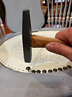 a person is using a knife to sharpen a piece of wood on a white plate