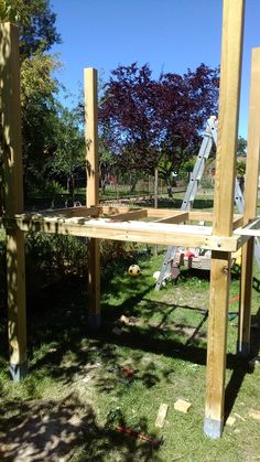 a wooden structure being built in the grass