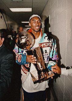 a man holding a trophy in his right hand