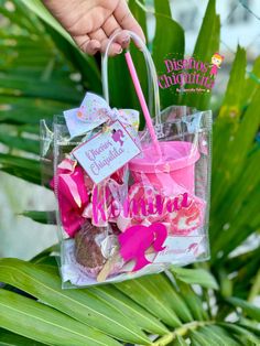 a person holding a pink and white bag filled with candy