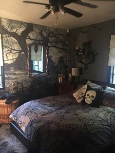 a bed room with a neatly made bed next to two windows and a ceiling fan