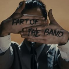 a man covering his face with both hands and the words part of the band written on it