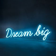 a neon sign that says dream big in white letters on a black background with the word below it