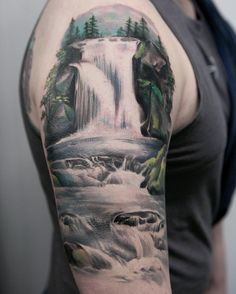 a man with a waterfall tattoo on his arm