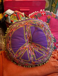 an assortment of colorful pillows and other decorative items