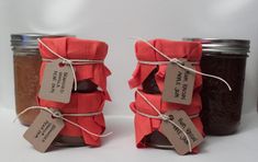 two jars filled with jam sitting next to each other