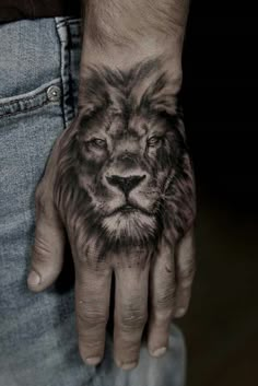 a man's hand with a lion tattoo on it