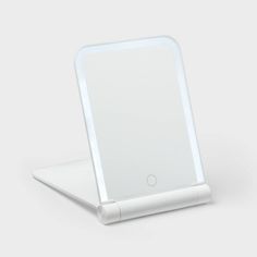 an electronic device with a white surface on it's display stand, showing the back side of the device