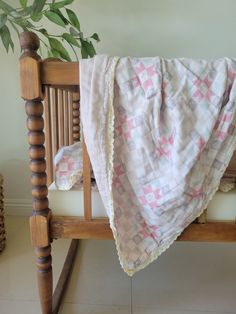 a wooden bed with a blanket on top of it