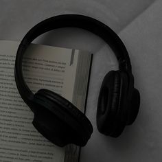 headphones resting on top of an open book