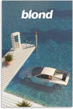 a white car parked on top of a swimming pool next to a building with the word blond written above it