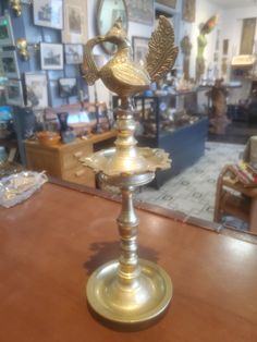 an ornate brass candle holder on a wooden table