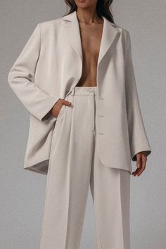 She’s an icon, she’s a legend and she IS the moment. The Icon Tailored Set takes a modern twist on a classic silhouette by featuring an oversized/relaxed fit to give it that edgy, street style flare. Add this to your cart if you’re ready to officially enter your Hailey Bieber era. COLOR: CREAM DETAILS Sold as a set TOP: Single-breasted blazer, relaxed/oversized fit, front button closure, lightly padded shoulders and back belt tightening BOTTOM: Relaxed fit, front zipper and button fastening, twi Chic Oversized Outerwear, Chic White Outerwear With Pressed Crease, Elegant Everyday White Outerwear, Chic Everyday Blazer, Everyday Oversized Blazer, White Outerwear With Pressed Crease For Fall, Elegant White Oversized Blazer, Chic Beige Blazer For Everyday Wear, Chic Relaxed Fit Blazer For Fall