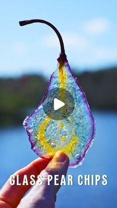 a hand holding a piece of glass with water on it and the words glass pear chips