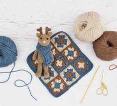 crocheted items are laid out on a white table