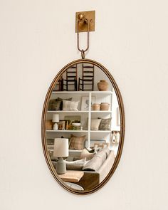 a mirror hanging on the wall above a couch