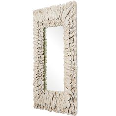 a white wall mirror sitting on top of a wooden frame