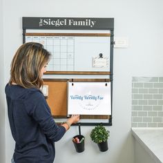 a woman standing in front of a bulletin board