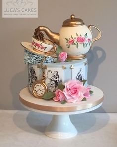 there is a cake decorated with teapots and flowers