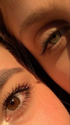 two women with long lashes and brown eyes looking in the same direction at the camera