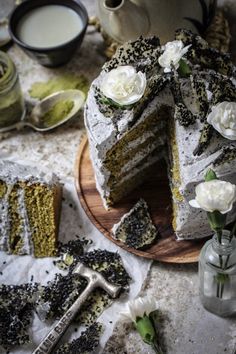 there is a cake that has been cut and served on a plate with flowers next to it